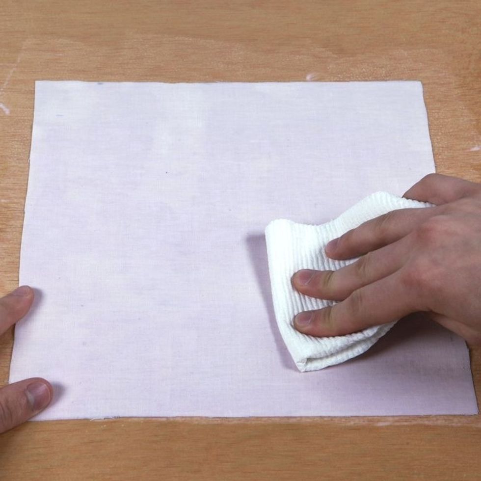 Using a paper towel, blot material to soak up excess dye. Tip: Less is more! Material should be fully coated but excess moisture can cause imperfections in prints. Material should be damp, not soaked.