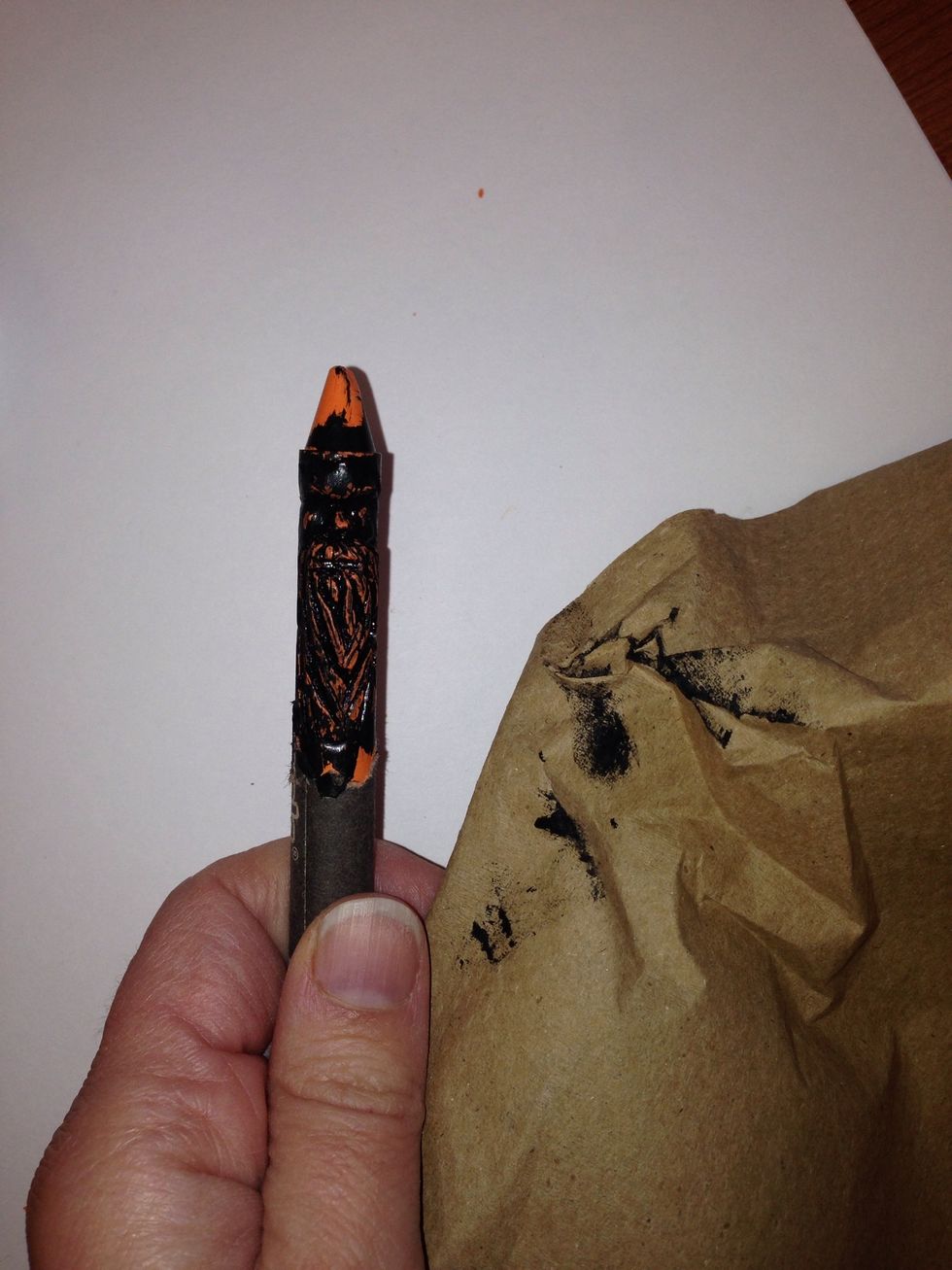 Using a paper towel rub over crayon leaving only the lines and carved area with black paint