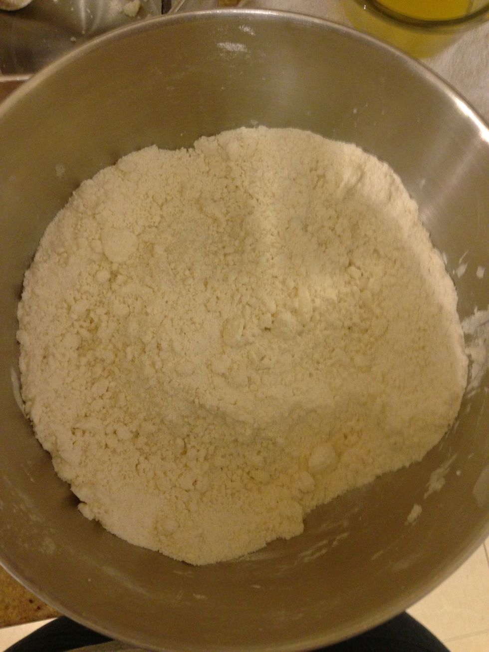 Using a pastry cutter cut in coconut oil until mixture resembles coarse crumbs.