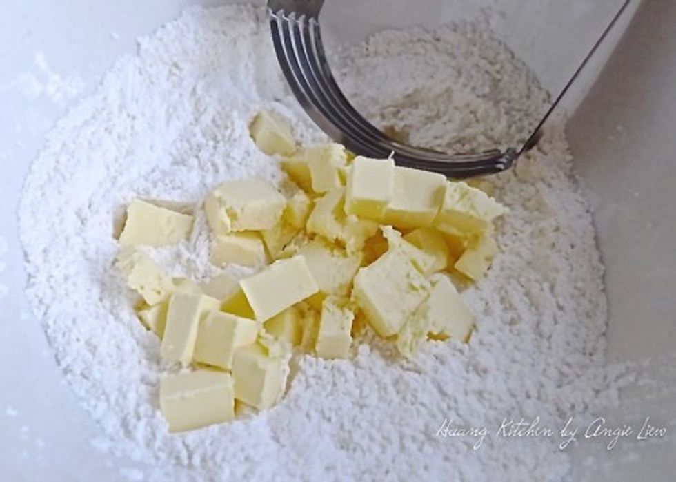 Using a pastry cutter, cut the cold butter into the flour. You can also use a food processor to do this.
