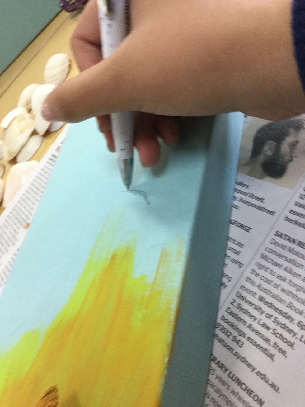 Using a pen, mark out your sand for your beach. This can be any size or shape.