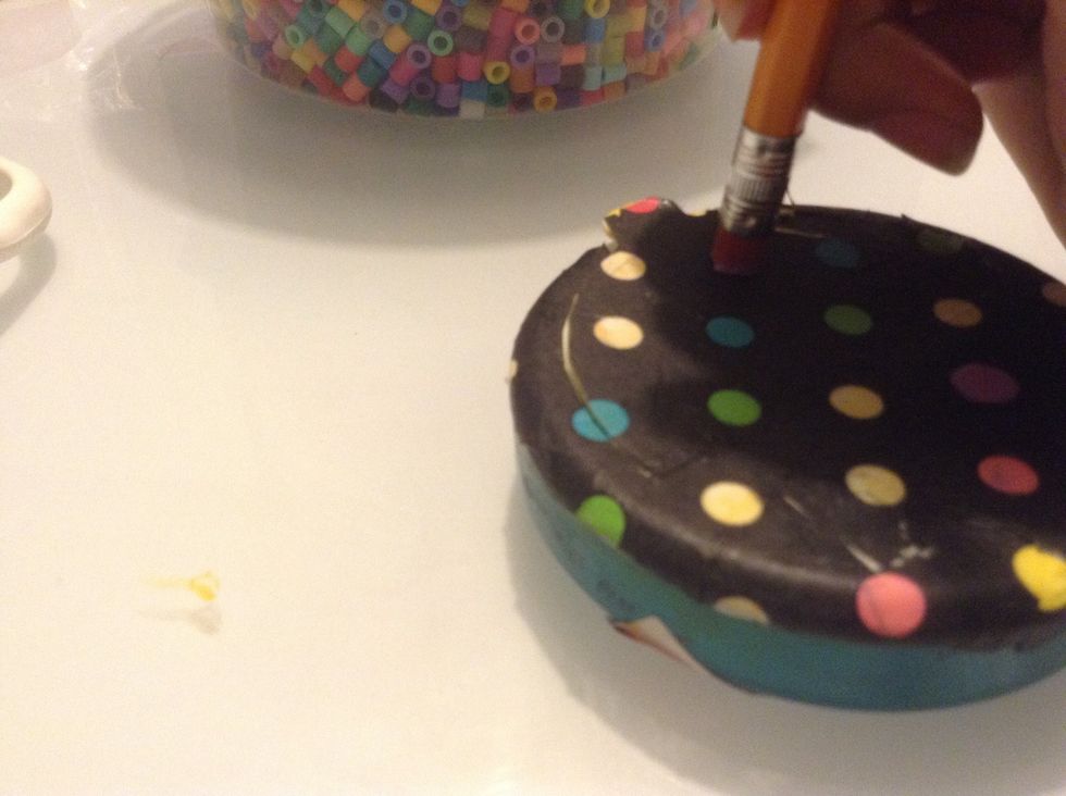 Using a pencil eraser and the nail polish, make little dots all over the paper. Repeat with the rest of the colors.