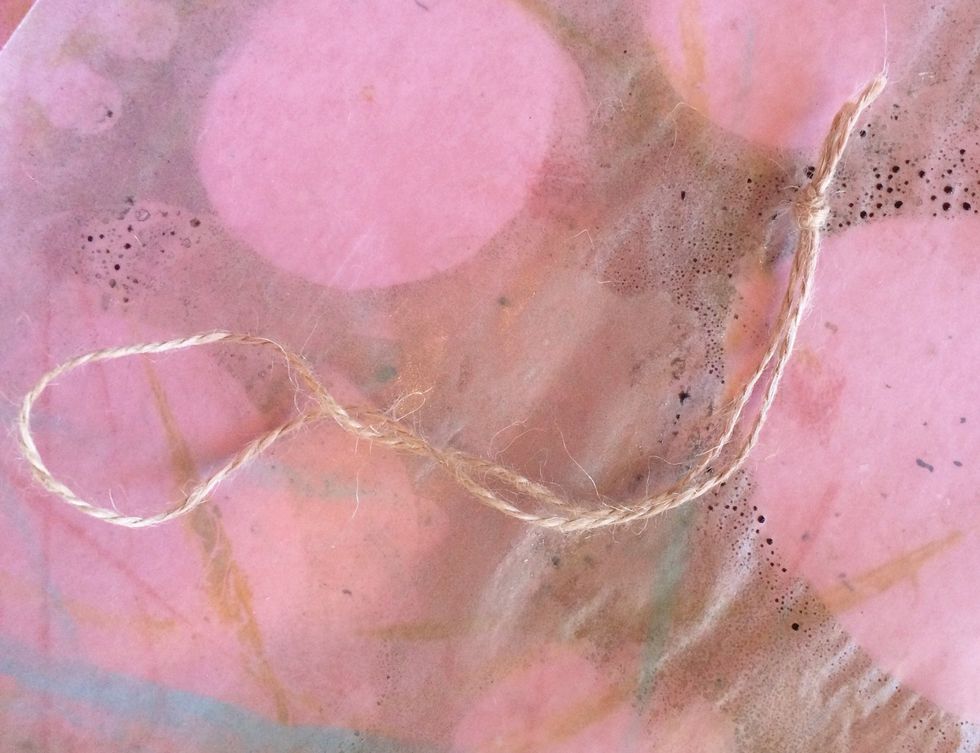 Using a piece of hemp or just that is about 12-14 in, fold it in half and  knot the lose end (not the looped end.)