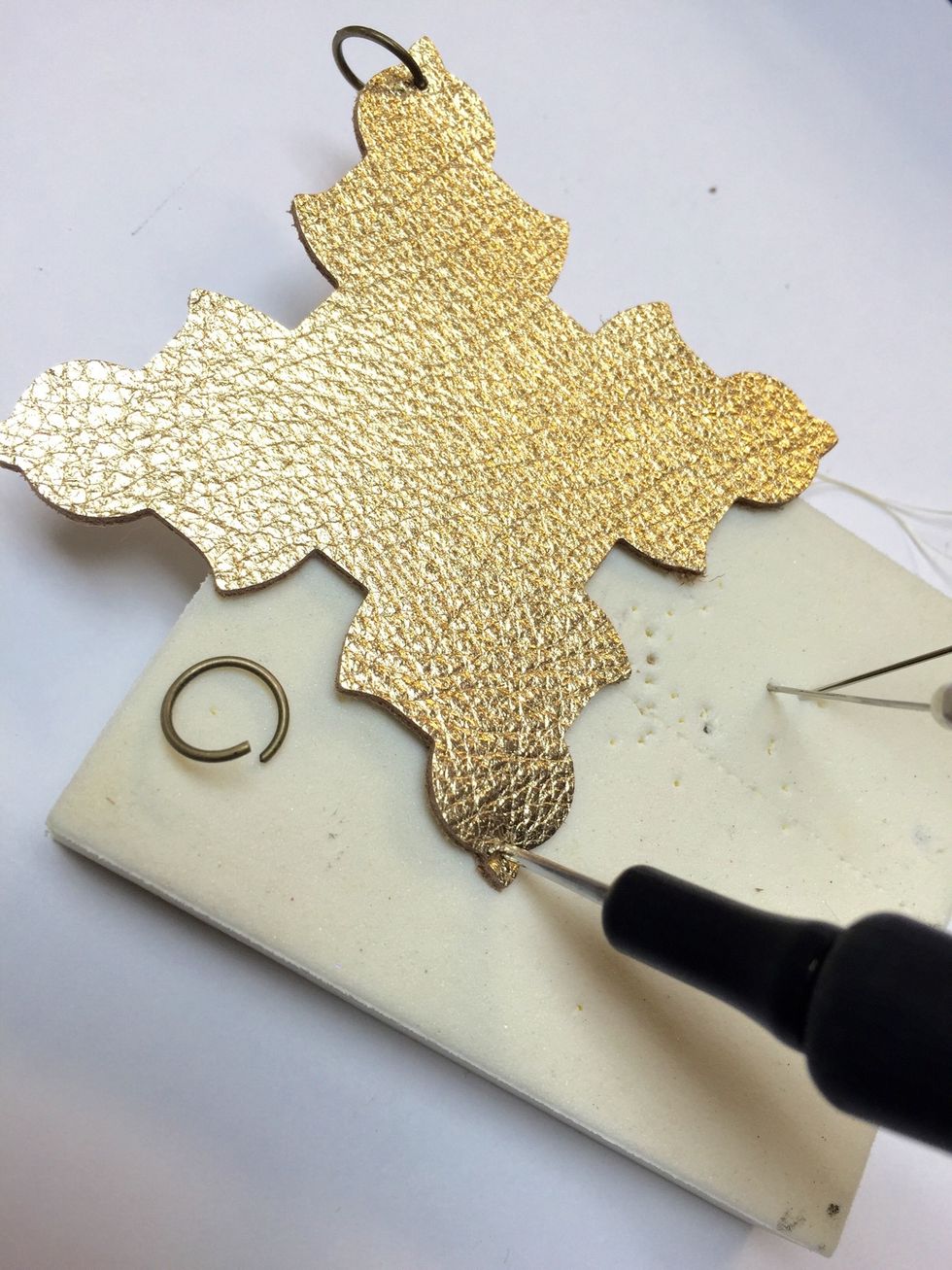 Using a piercer make holes in the leather