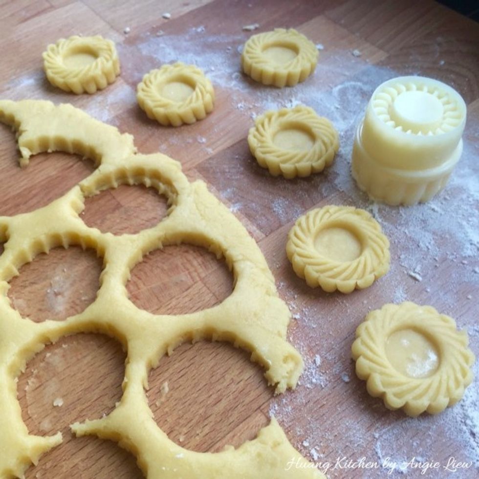 Using a pineapple tart mould, stamp into 3 cm rounds of tart shells. Press firmly on the dough and dislodge the tart shells carefully from mould.