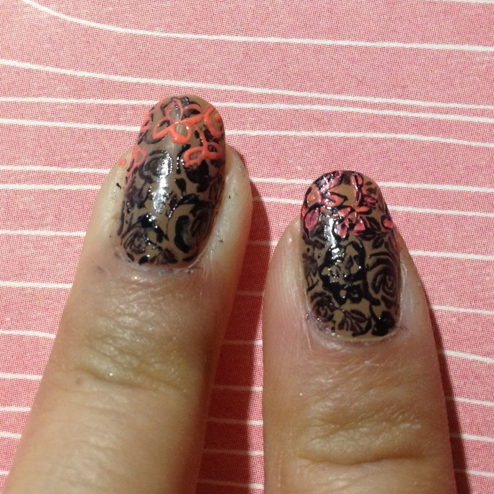 Using a pink polish, create outlines of flower petals, swirls and leave near the top of your nails. This should cover up the rest of the negative space.