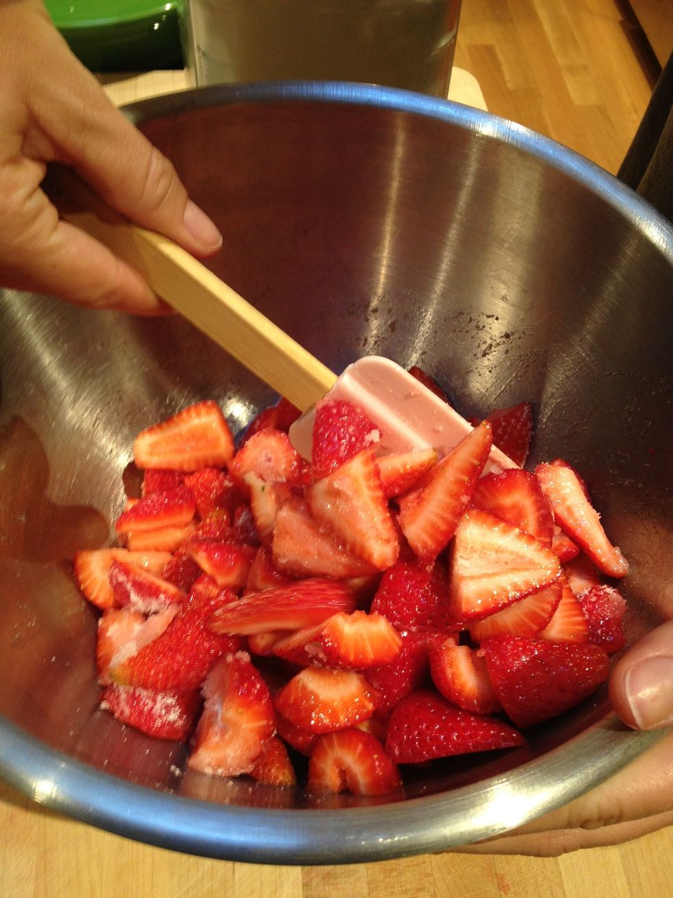 Using a plastic spatula, gently fold the sugar in. Make sure the strawberries are evenly coated.