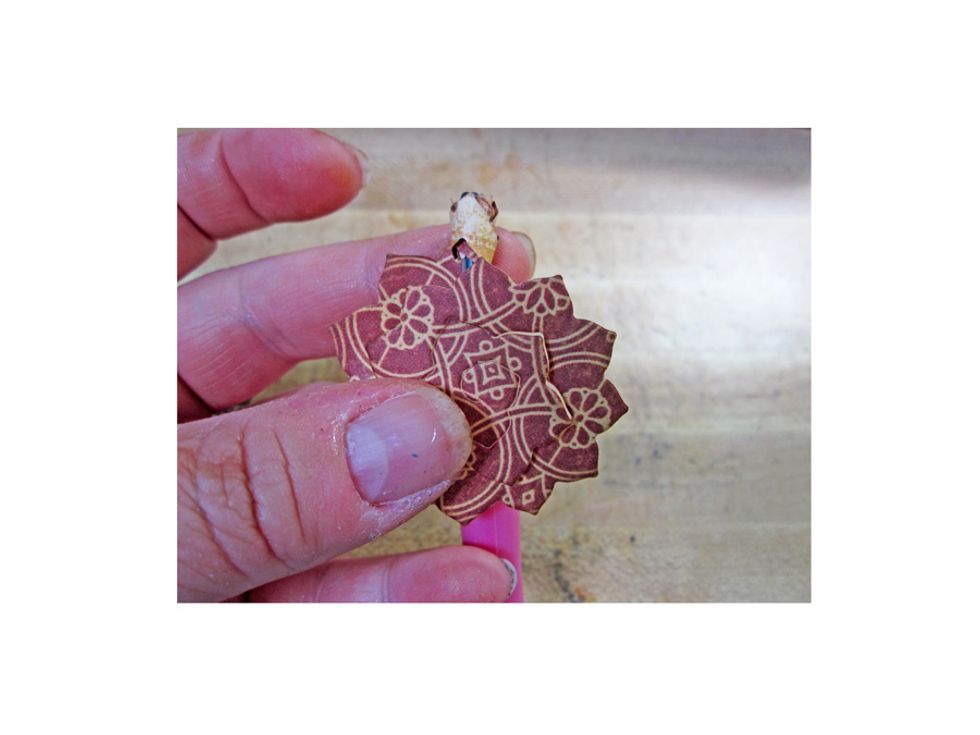 Using a quilling tool roll the pinecones into flowers from the outside in to create one of kind flowers. Glue down the flower once you have achieved the desired shape.