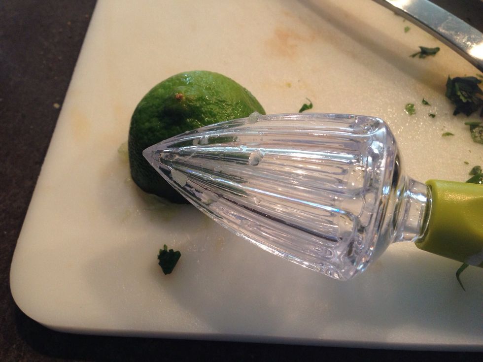Using a reamer, or your brute strength, squeeze half a lime into your salsa.