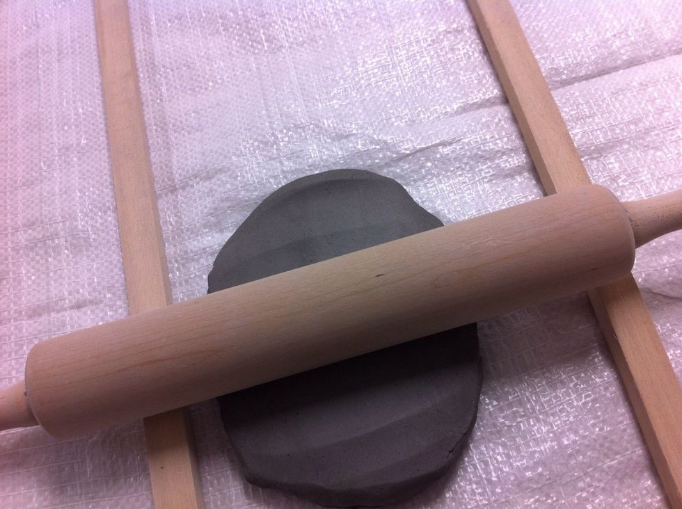 Using a rolling pin and some wood slats roll out a slab of clay. Note: S-2 is sticky, but it doesn't stick to the rolling pin.