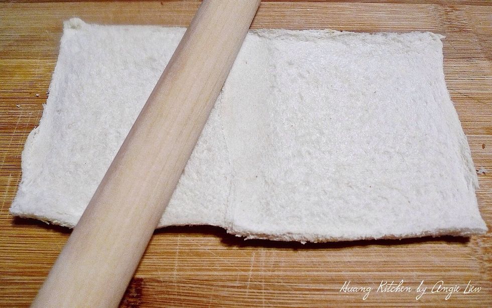 Using a rolling pin, flatten the 2 slices of bread to as thin as possible. This helps to join the bread together.