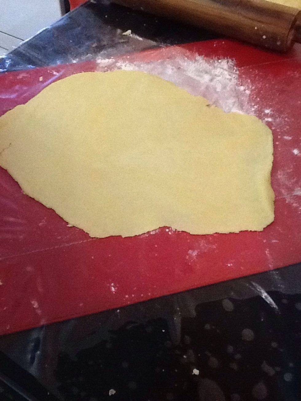 Using a rolling pin roll one of the balls out into a thin layer