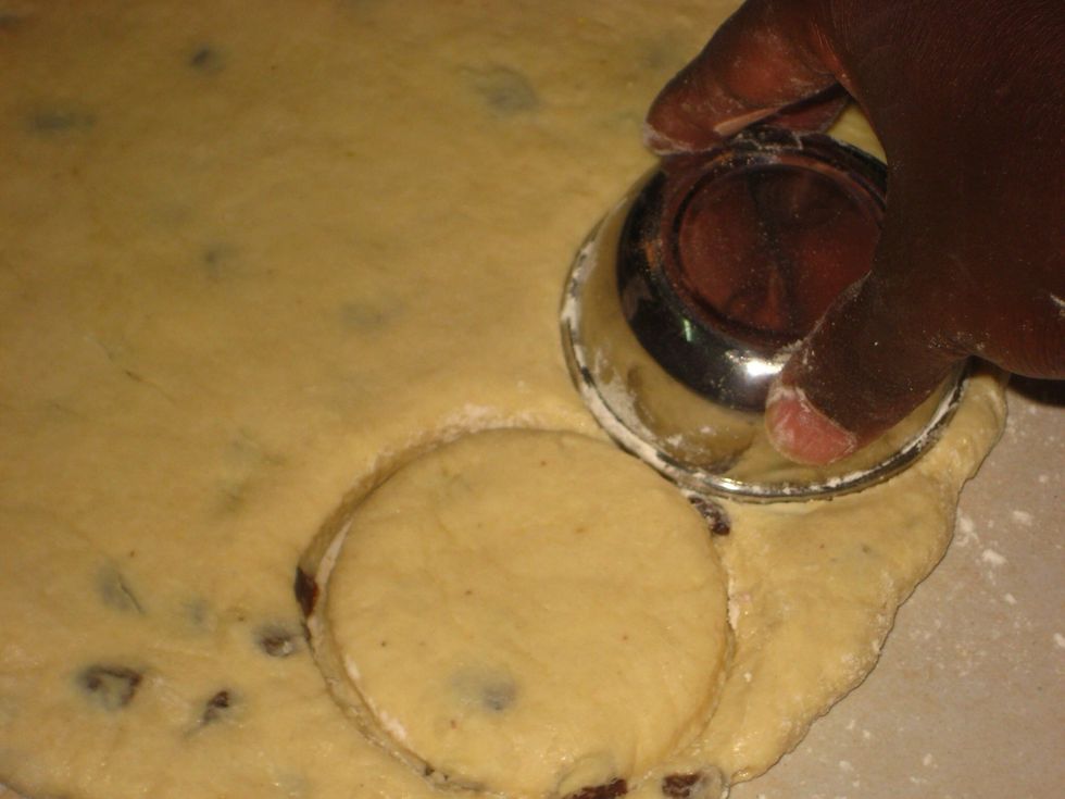 Using a round cutter/small container, press to cut rounds from the dough.