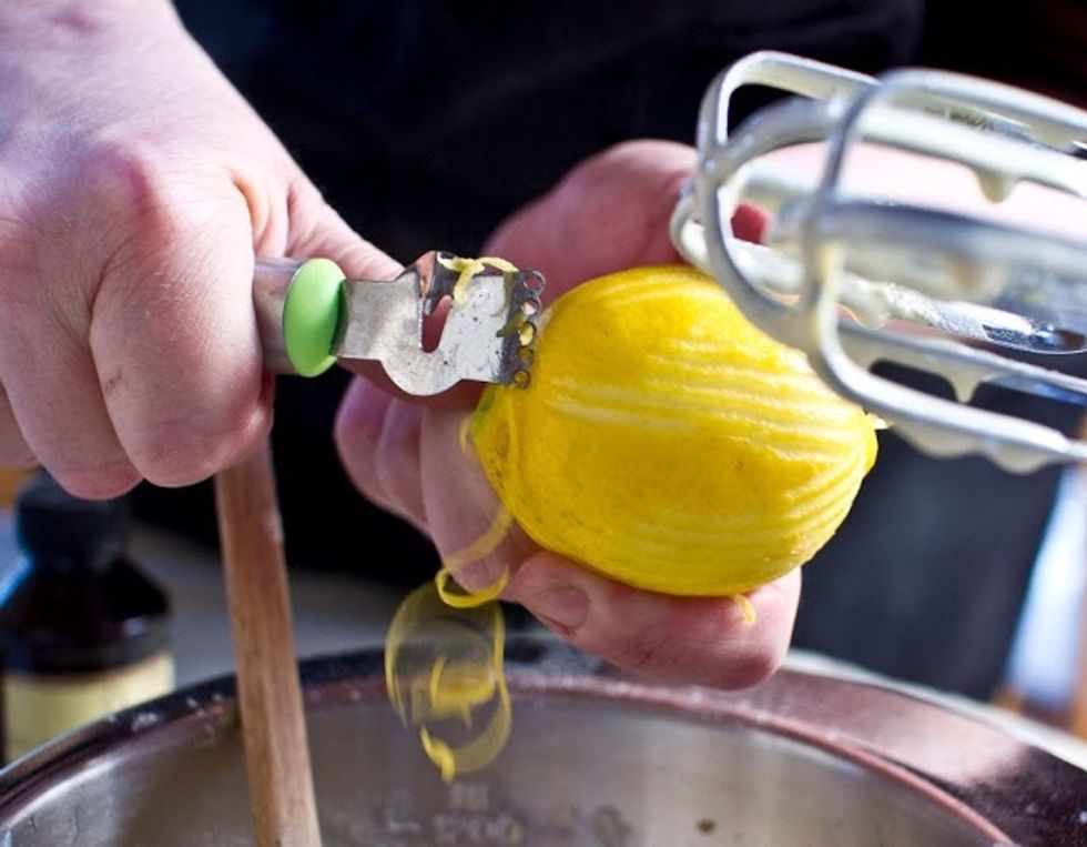 Using a rubber spatula, gently fold in the lemon zest......and half of the melted butter.