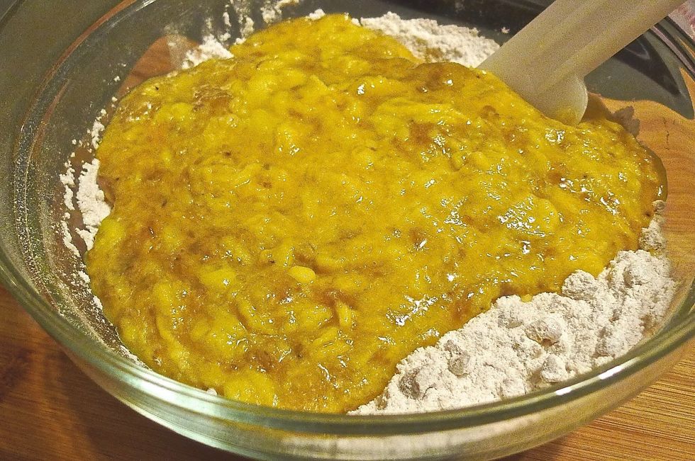Using a rubber spatula lightly fold the WET ingredients ( banana mixture ) into the DRY ingredients ( flour mixture ).