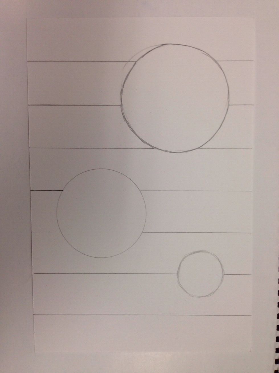 Using a ruler, draw vertical stripes across the paper. Do not draw inside the circles.