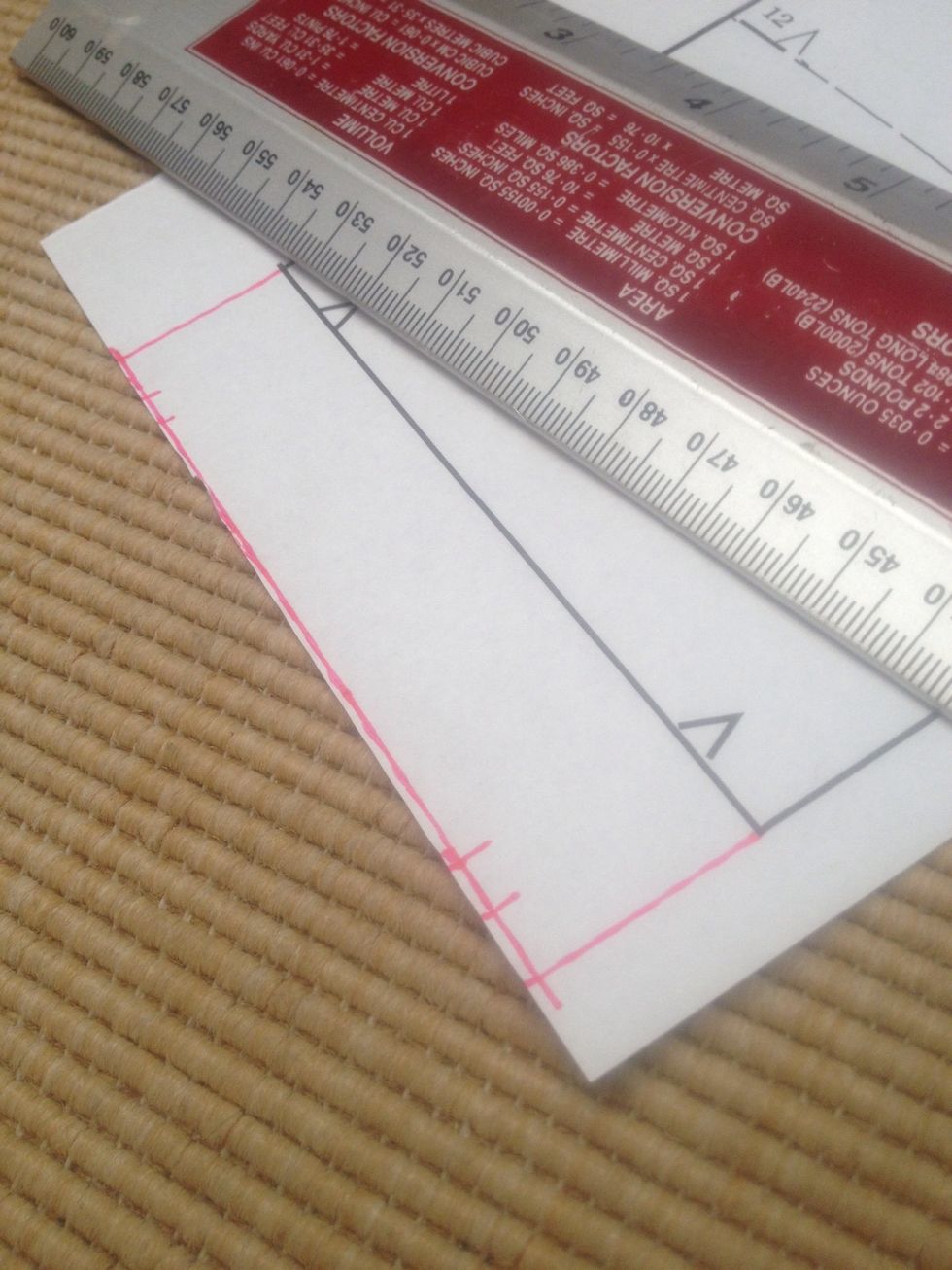 Using a ruler, measure down your desired length and join up both sides. Follow the line for the darts placement.