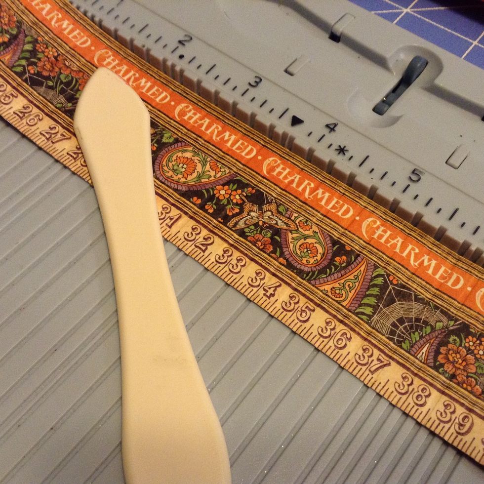 Using a scoring board, score a 1 1/2" x 12 " paper strip for your florets