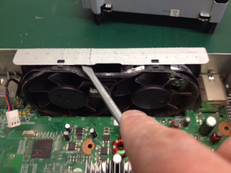 Using a screwdriver lever the fans out from under the case.