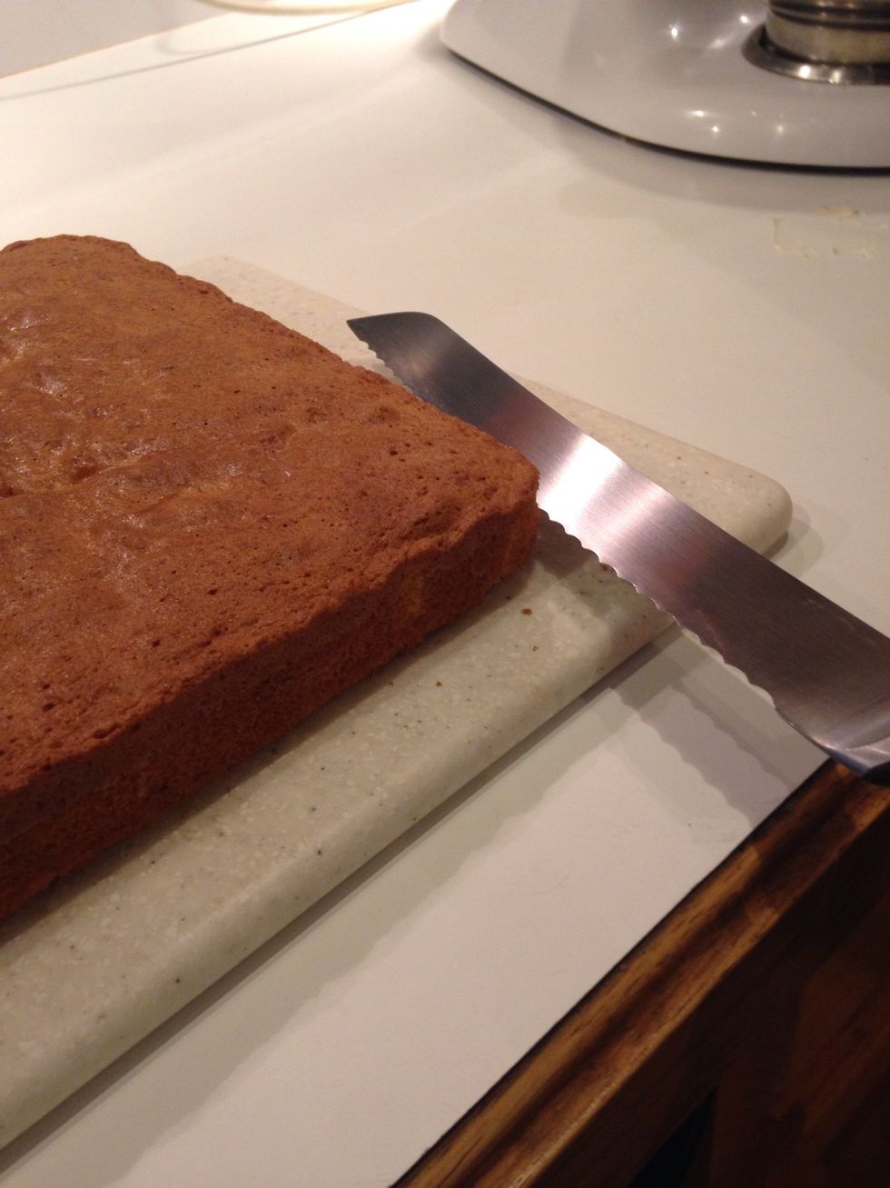 Using a serrated knife, cut off the top 1/3rd of the cake.