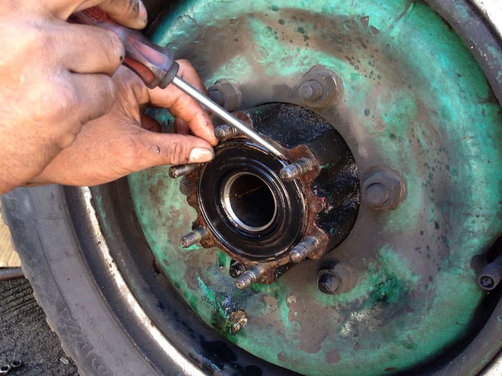 Using a sharp object, pull out the leaky oil seal.