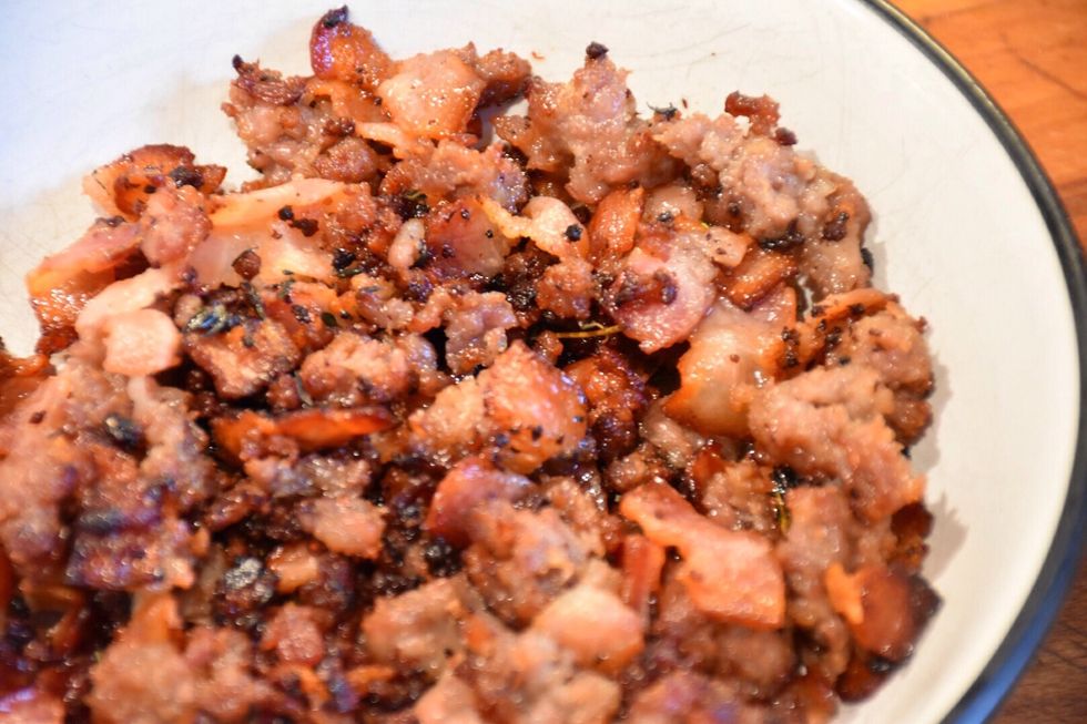 Using a slotted spoon remove bacon and sausage from pan into a bowl.  Let cool. Discard thyme sprigs. Leave bacon fat in frying pan.