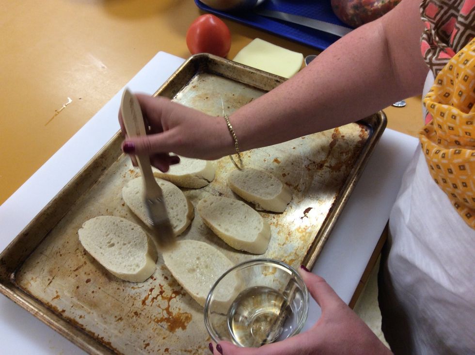 Using a small amount of oil, brush the top of the bread with a pastry brush. You don't want the bread to soak up tons of oil so be light when brushing.