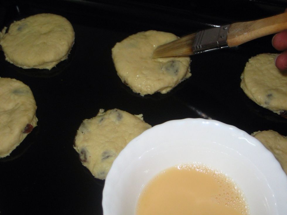 Using a small brush, apply the beaten eggs on the top of each piece. This will help in giving the finished scones a beautiful golden colour