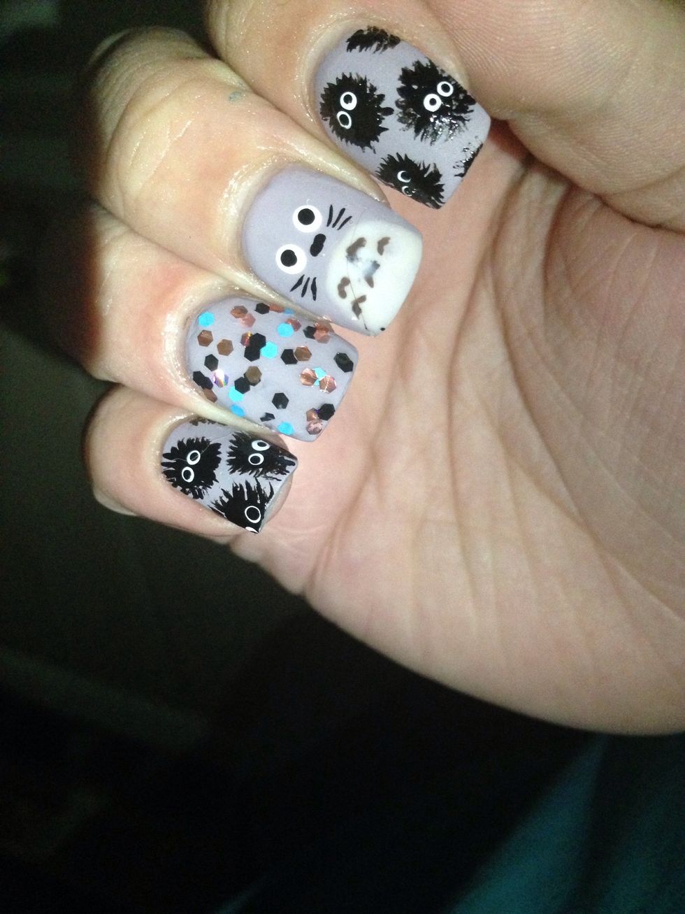 Using a small paintbrush add small lines coming out of the black circles.