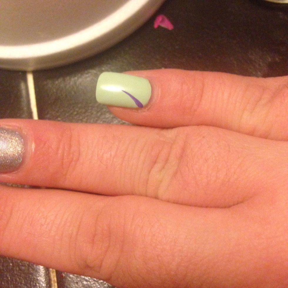 Using a small paintbrush paint a slightly curved line.