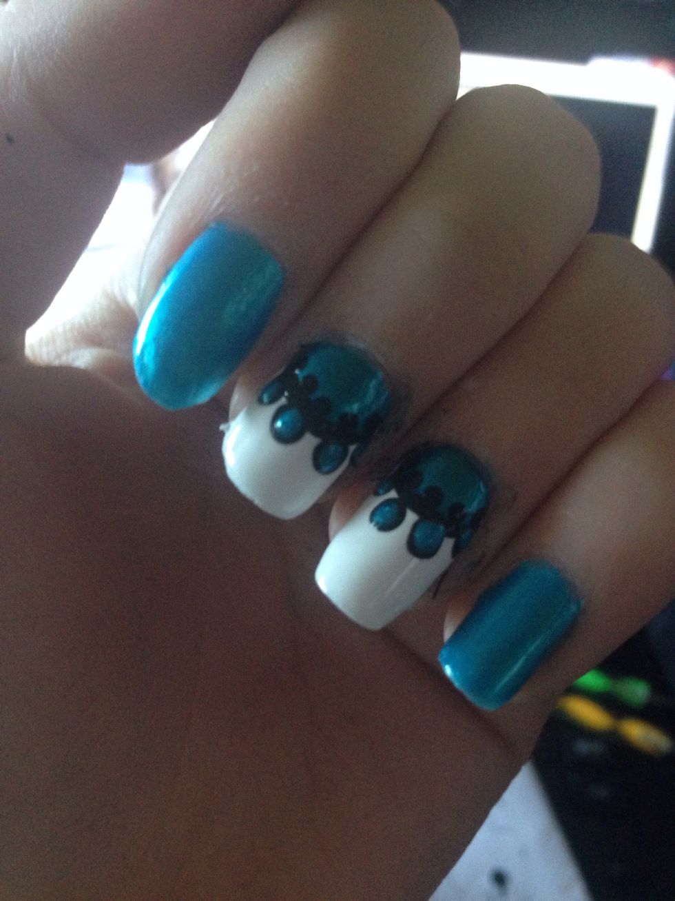 Using a smaller dotting tool, add black dots along the new inner edge of the original half circle. Also, put smaller blue dots into the big black ones.