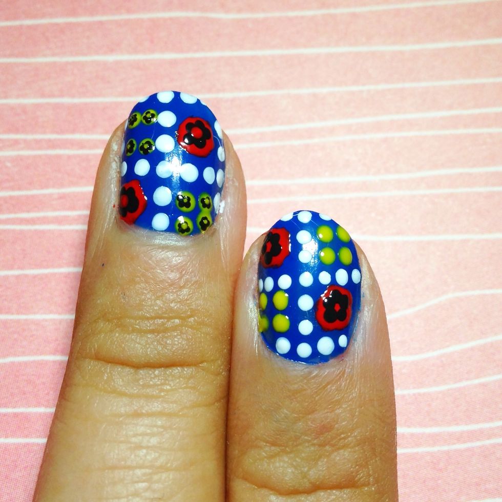 Using a smaller end of a dotter, create a 5 petal flower inside the red circle.