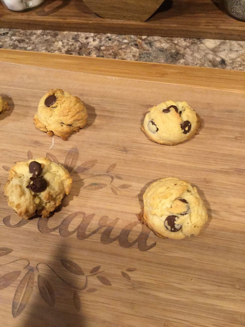 Using a spatula take your cookies off of the cookie pan and set them onto the wax paper. Let cool for five minutes before putting them into a plastic container. They're finished!