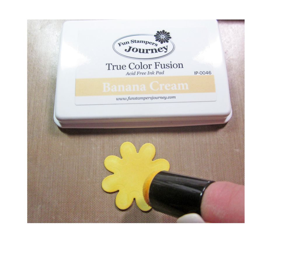Using a sponge dauber color the base petals with a yellow ink.