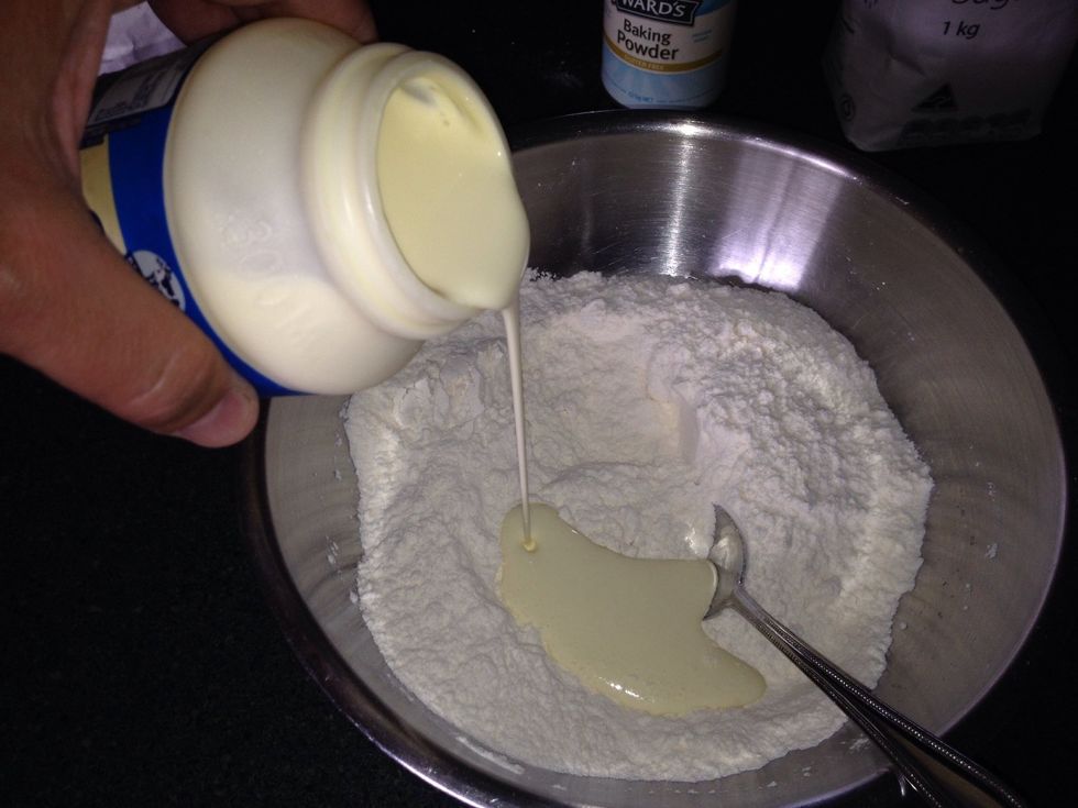 Using a spoon, mix the cream thoroughly until it comes together.