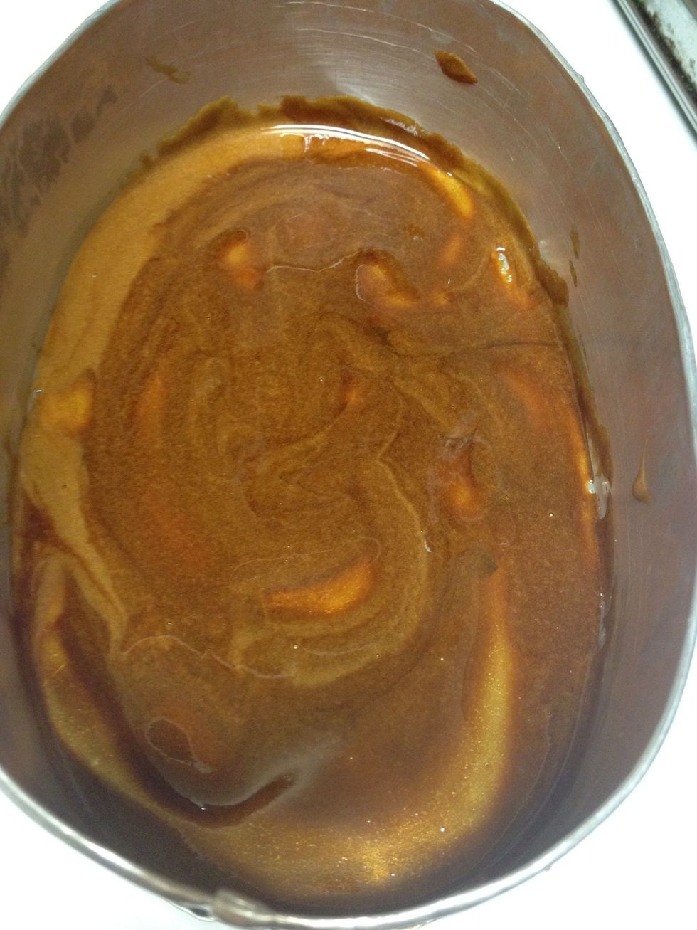 Using a spoon, spread the caramel evenly to cover the whole bottom of the pan. And quickly take it away from the stove.,just to make sure your caramel won't get burned.
