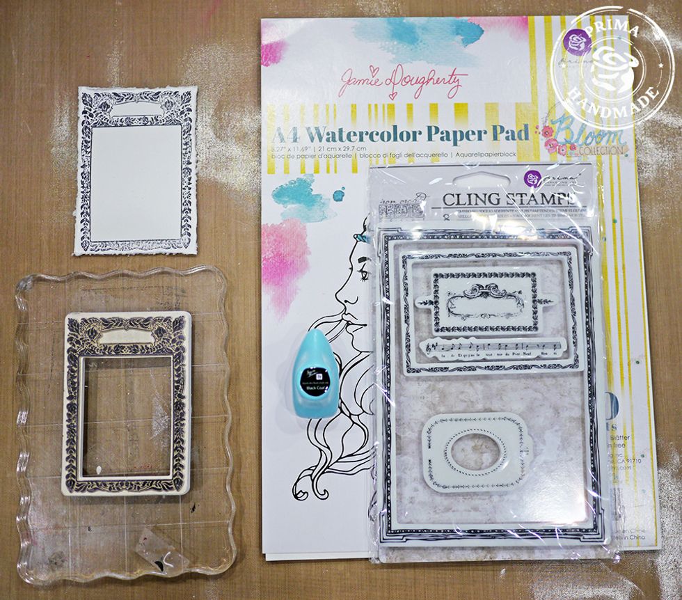 Using a stamp from the IOD stamp set, stamp on a piece of watercolor paper, trim and distress around edges.