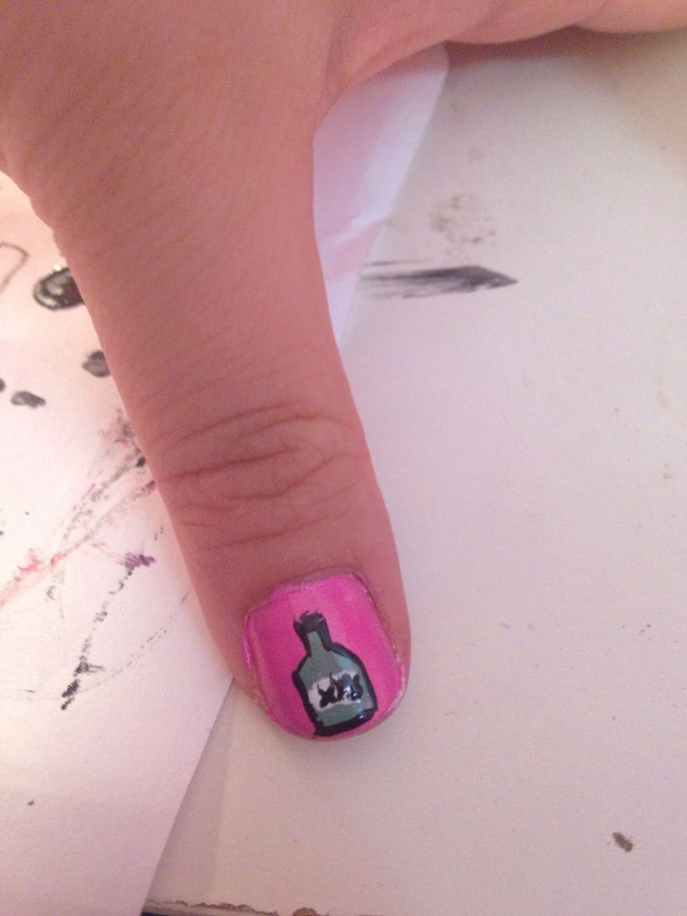 using a steady hand use a thin brush to outline the bottle. I created a label using white polish & then x's (hardest thing of life to make) with the same tiny brush. Lol yes those are x's