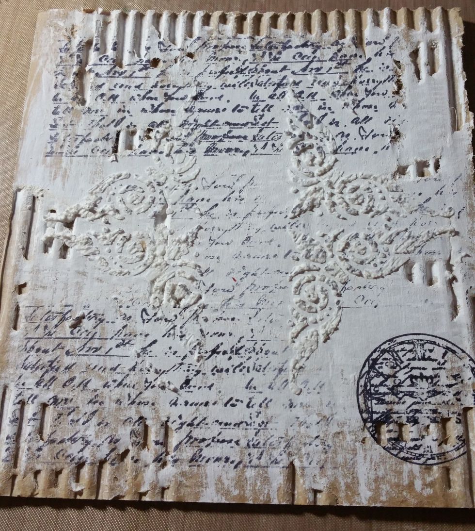 using a stencil and coarse texture paste I added the design on either side. Once that dries completely use a script stamp and various others to randomly add on top. Let dry completely!