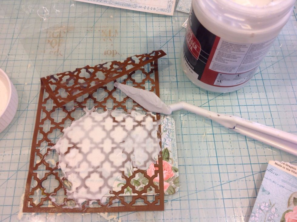 Using a stencil I applied modeling paste. Once dry I applied clear gesso all over tag to prime it for my inks.