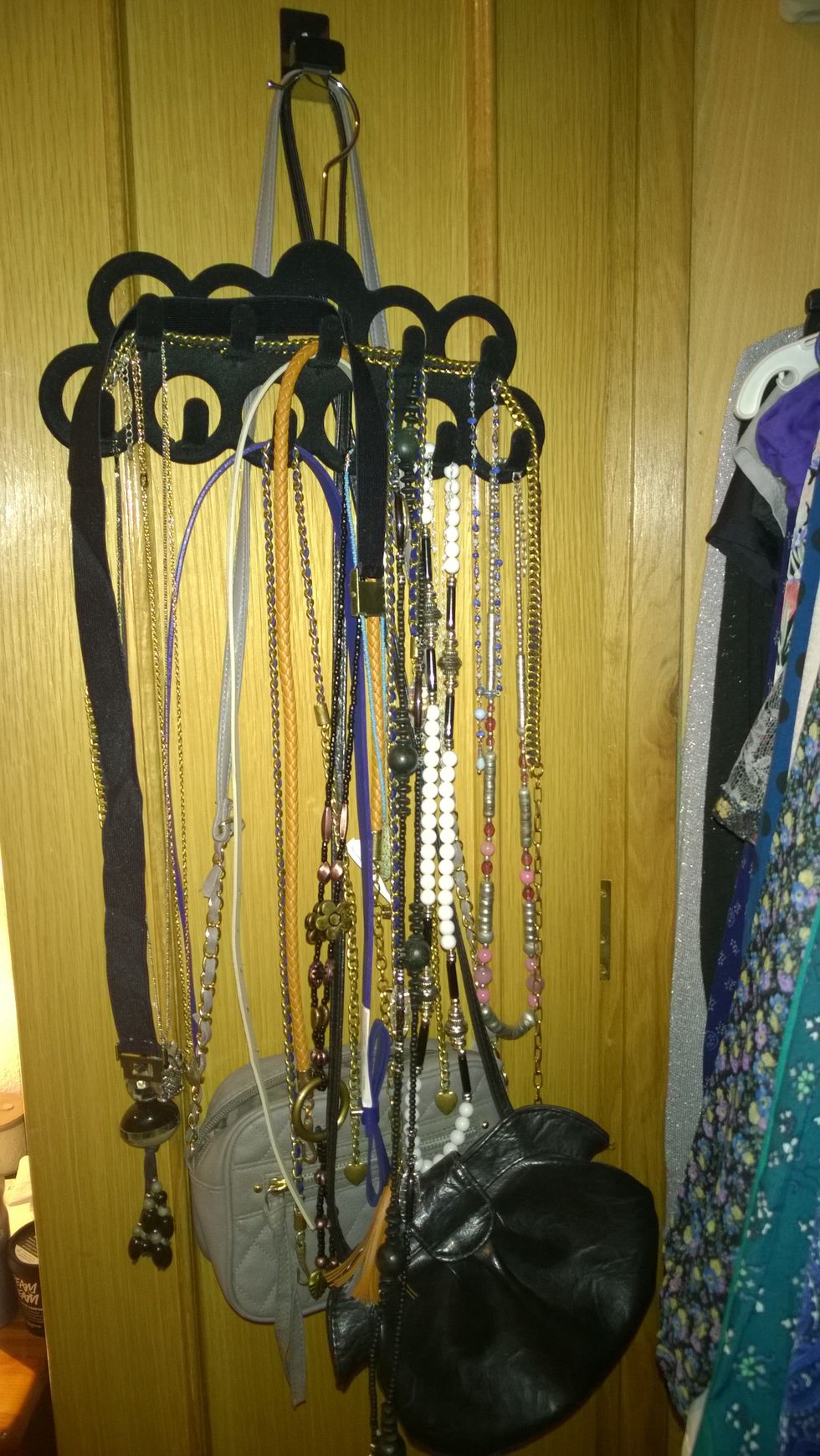 Using a sticky hook, and a special hanger (the ones for jewlery) you can hang your stuff even thin belts, small hadbags, etc. Again using the doors as part of the storage.