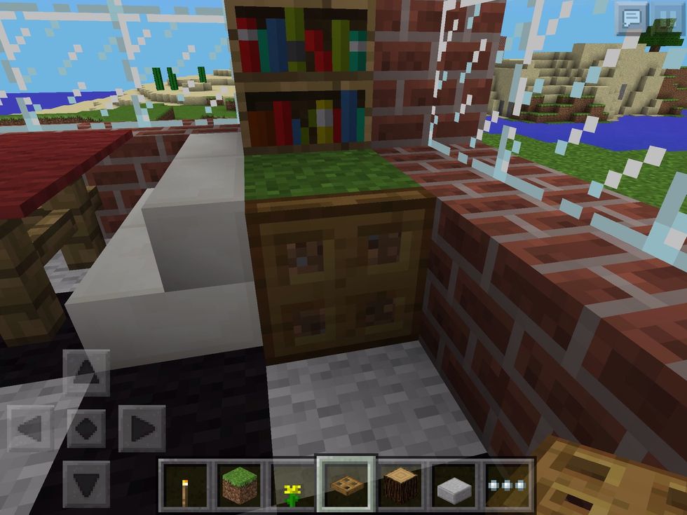 Using a trapdoor, place it next to the grass and lift it up. This hides the dirt and makes a lovely flowerpot!