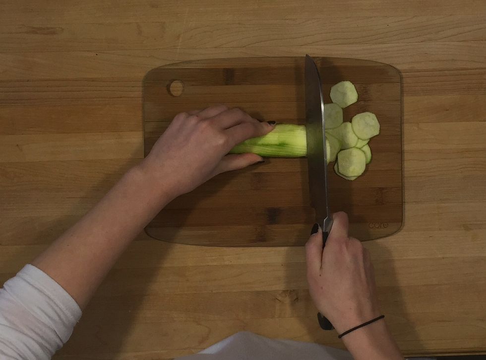 Using a very sharp knife, slice zucchini as thin as possible.