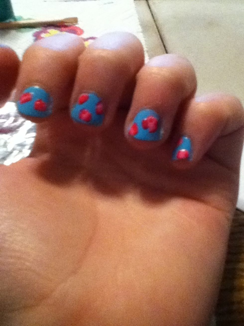 Using a very small dotting tool (or toothpick) make curved lines to give the flower depth with the dark color.