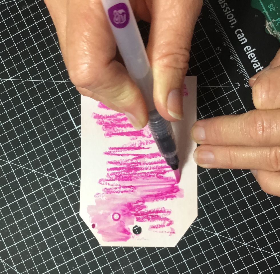 Using a watercolour pen, start blending the watercolour oil pastel.