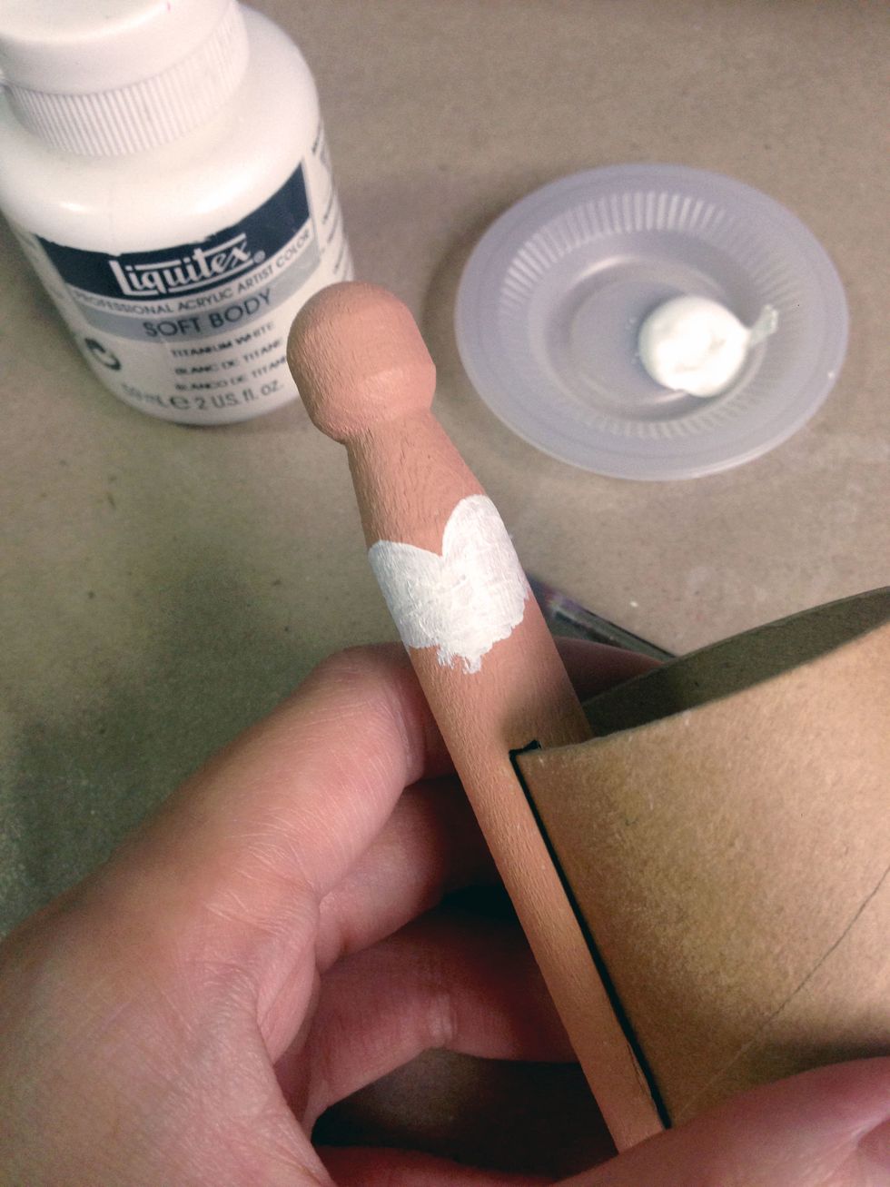 Using a white acrylic paint, paint a heart shaped corset onto the clothespin peg...