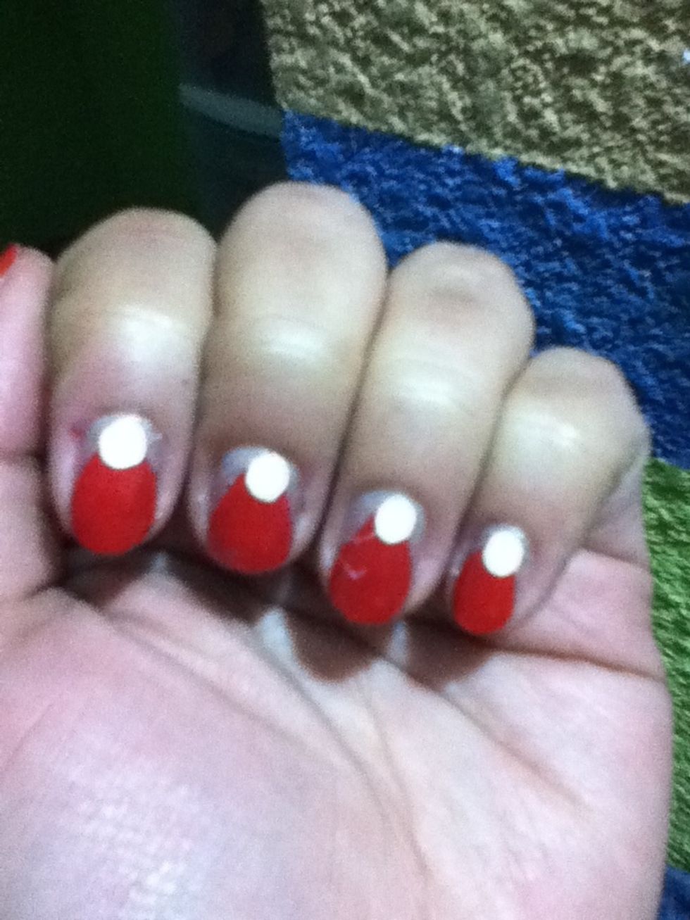 Using a white nail polish and a big dotting tool make a dot on the top of the triangle