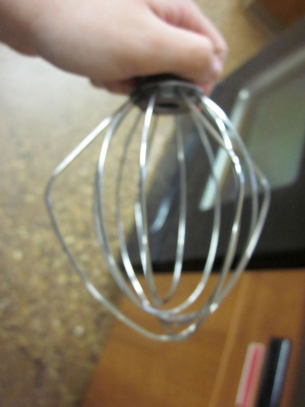Using a wire attachment for the mixer to whisk the heavy whipping cream.