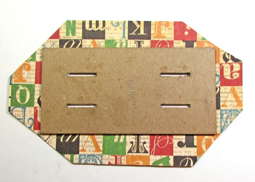 Using a wrapping method, attach G45 Typography paper to the holder base. Miter corners.
