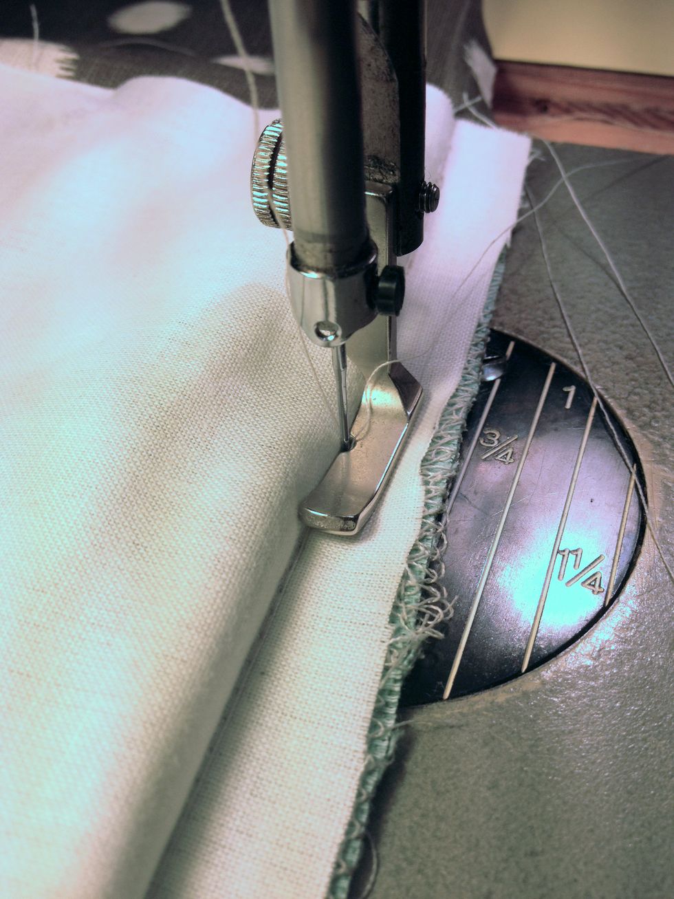 Using a zipper foot on your machine, stitch all layers together. Make sure to stitch right next to the piping.